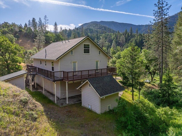 12876 E Fork Rd, French Gulch, CA 96033 - rear view of house with a deck with mountain view, stairway, and a wooded view