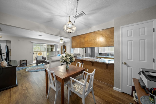 200 Ridgetop Dr # 26, Redding, CA 96003 - dining area featuring wood-type flooring, a chandelier, ceiling fan, a textured ceiling, and baseboards