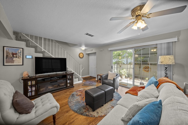200 Ridgetop Dr # 26, Redding, CA 96003 - living area with stairs, a ceiling fan, wood finished floors, and a textured ceiling