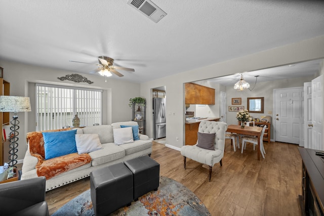 200 Ridgetop Dr # 26, Redding, CA 96003 - living room featuring a ceiling fan, light wood-type flooring, plenty of natural light, a textured ceiling, and baseboards