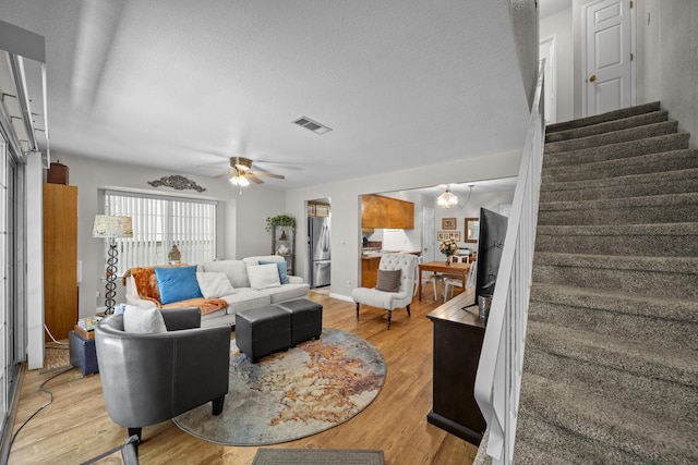200 Ridgetop Dr # 26, Redding, CA 96003 - living area with stairs, light wood-style floors, a ceiling fan, and a textured ceiling