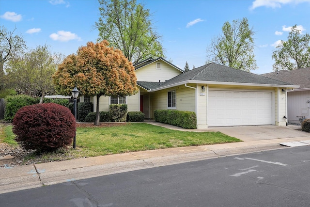 117 Yolla Bolly Trl, Redding, CA 96003 - view of front facade featuring an attached garage, concrete driveway, a front lawn, and roof with shingles