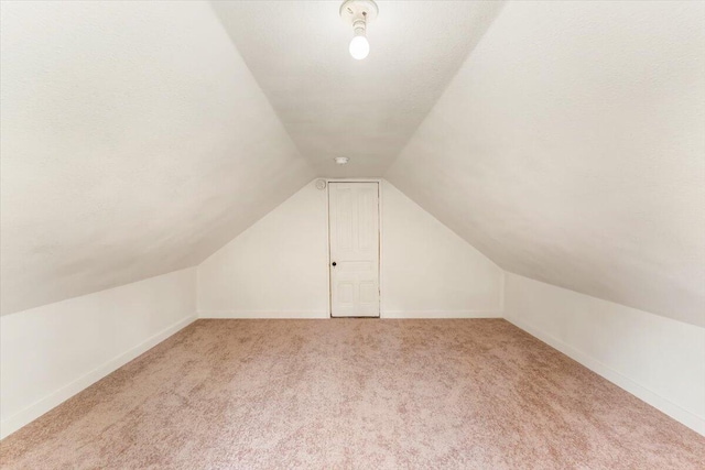 5985 Dunsmuir Ave, Dunsmuir, CA 96025 - additional living space with light carpet, vaulted ceiling, and baseboards
