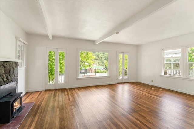 5985 Dunsmuir Ave, Dunsmuir, CA 96025 - unfurnished living room with hardwood / wood-style flooring, beamed ceiling, baseboards, and a wood stove