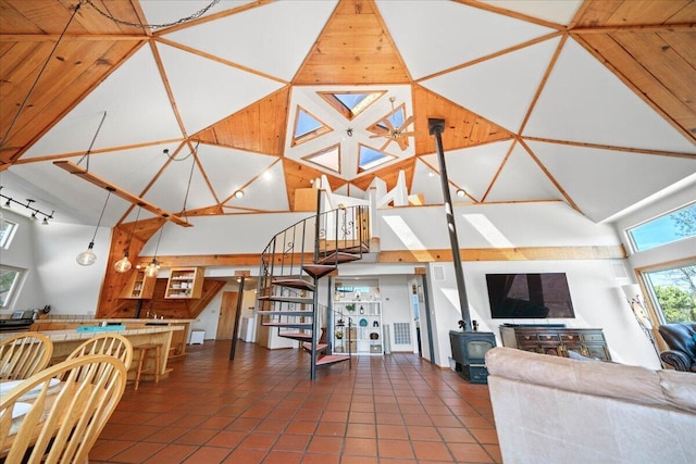 19028 Rocky Trl, Lakehead, CA 96051 - living area with a high ceiling, a wood stove, tile patterned flooring, and stairway