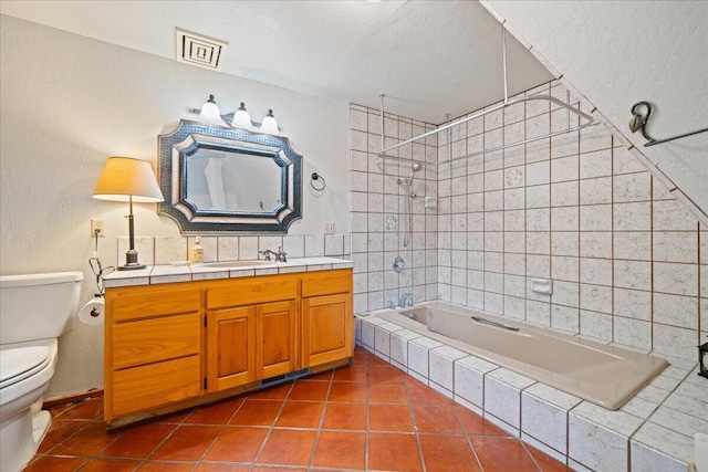 19028 Rocky Trl, Lakehead, CA 96051 - full bathroom with toilet, tiled shower / bath combo, tile patterned floors, a textured ceiling, and vanity