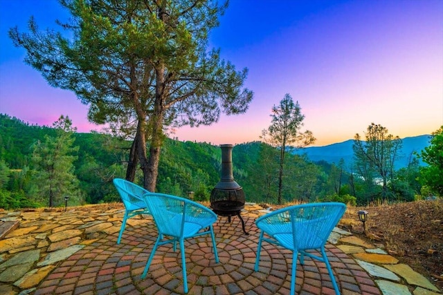 19028 Rocky Trl, Lakehead, CA 96051 - patio terrace at dusk with a fire pit and a mountain view