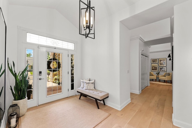 2154 Harvard Way, Redding, CA 96003 - entrance foyer featuring a chandelier, light wood finished floors, baseboards, and high vaulted ceiling
