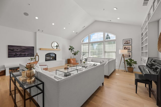 2154 Harvard Way, Redding, CA 96003 - living area featuring a glass covered fireplace, light wood-type flooring, recessed lighting, and high vaulted ceiling