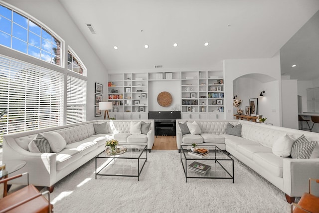 2154 Harvard Way, Redding, CA 96003 - living area with wood finished floors, arched walkways, recessed lighting, built in features, and a towering ceiling