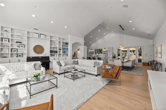 2154 Harvard Way, Redding, CA 96003 - living room featuring high vaulted ceiling, light wood finished floors, arched walkways, recessed lighting, and built in features