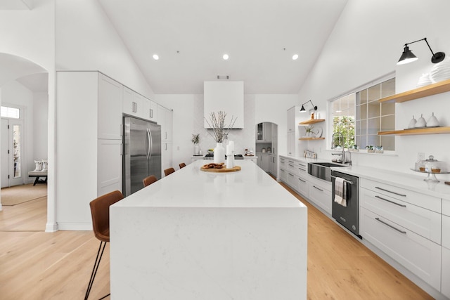 2154 Harvard Way, Redding, CA 96003 - kitchen featuring arched walkways, open shelves, stainless steel appliances, high vaulted ceiling, and a sink