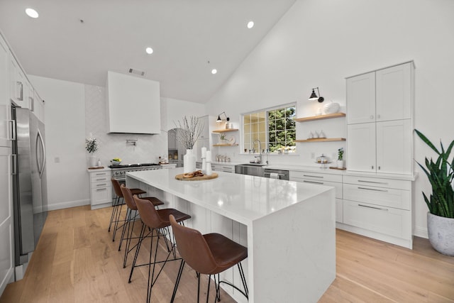 2154 Harvard Way, Redding, CA 96003 - kitchen with open shelves, appliances with stainless steel finishes, a sink, a kitchen bar, and recessed lighting