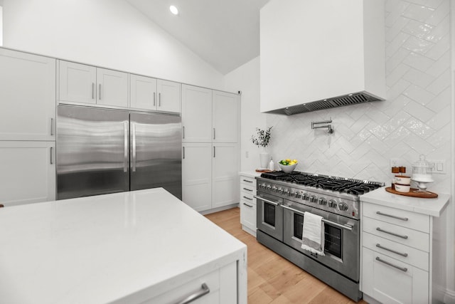 2154 Harvard Way, Redding, CA 96003 - kitchen with high end appliances, lofted ceiling, backsplash, white cabinets, and recessed lighting