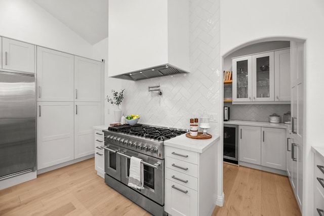 2154 Harvard Way, Redding, CA 96003 - kitchen with high quality appliances, wall chimney exhaust hood, wine cooler, light wood finished floors, and lofted ceiling