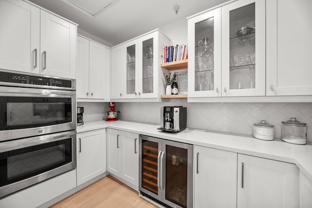 2154 Harvard Way, Redding, CA 96003 - kitchen with wine cooler, stainless steel double oven, light countertops, and backsplash