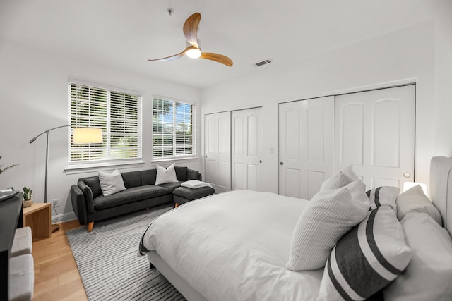 2154 Harvard Way, Redding, CA 96003 - bedroom featuring multiple closets, light wood-style floors, ceiling fan, and baseboards