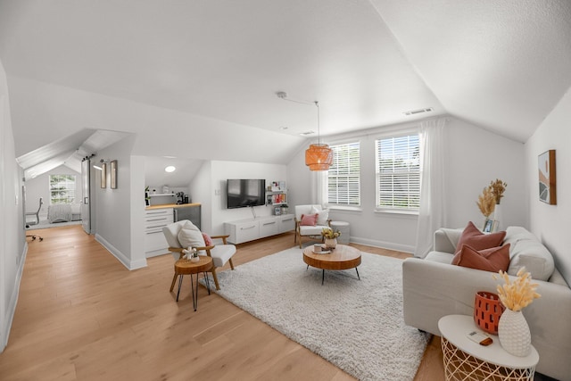 2154 Harvard Way, Redding, CA 96003 - living room featuring lofted ceiling, light wood-style flooring, and baseboards