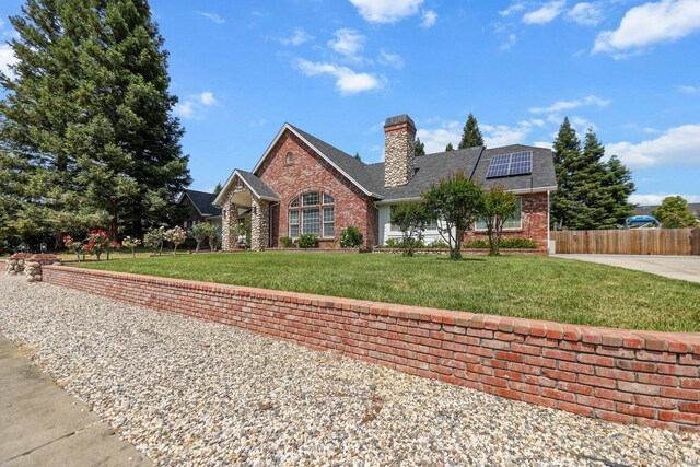 2154 Harvard Way, Redding, CA 96003 - traditional-style house with brick siding, solar panels, a chimney, and a shingled roof