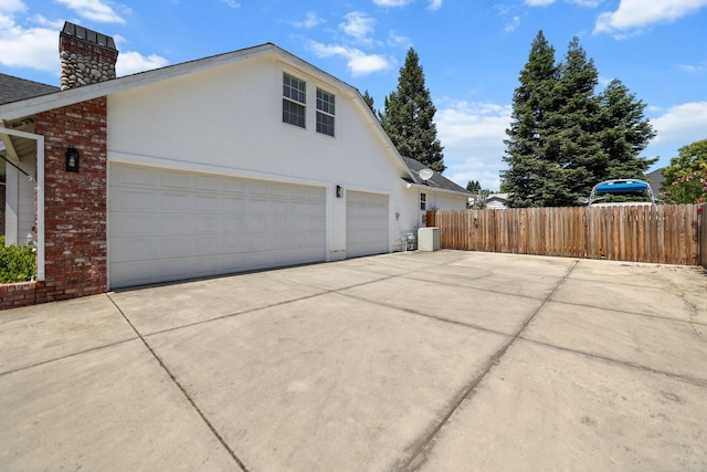 2154 Harvard Way, Redding, CA 96003 - view of property exterior featuring driveway, a chimney, fence, brick siding, and stucco siding