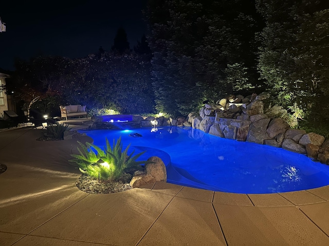 2154 Harvard Way, Redding, CA 96003 - pool at night featuring a patio area, a hot tub, and an outdoor pool