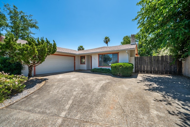 2683 Starlight Blvd, Redding, CA 96001 - single story home with concrete driveway, a garage, and a chimney