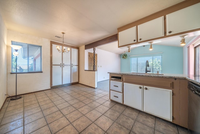 2683 Starlight Blvd, Redding, CA 96001 - kitchen with stainless steel dishwasher, a chandelier, white cabinets, hanging light fixtures, and light tile patterned floors