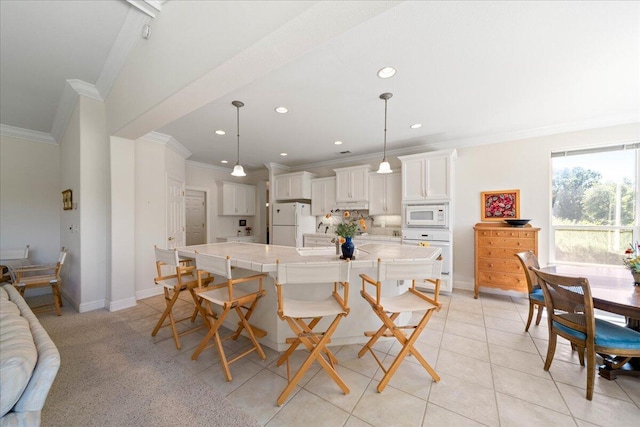 110 Agua Verdi Dr, Red Bluff, CA 96080 - kitchen with white appliances, ornamental molding, white cabinetry, baseboards, and a breakfast bar area