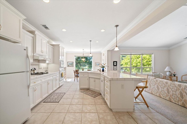 110 Agua Verdi Dr, Red Bluff, CA 96080 - kitchen featuring white appliances, tile countertops, crown molding, under cabinet range hood, and open floor plan