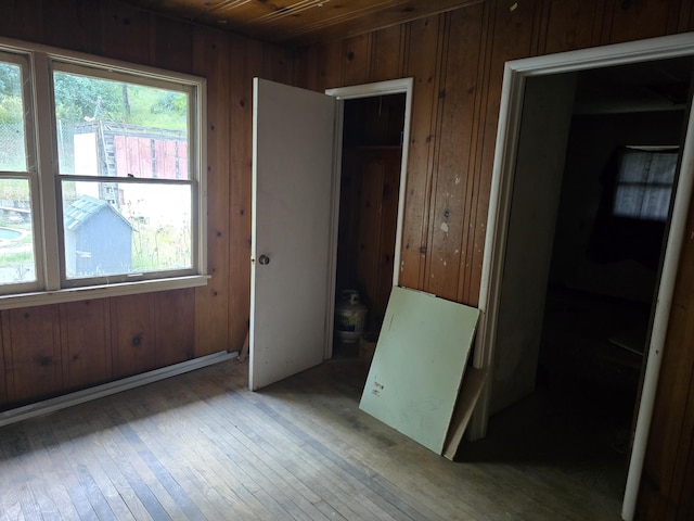 4680 Cedars Rd, Redding, CA 96001 - unfurnished bedroom with wooden walls, multiple windows, wood ceiling, and hardwood / wood-style flooring