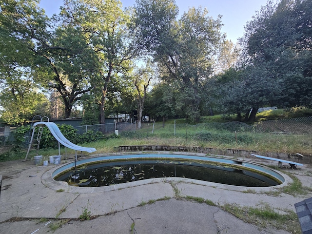 4680 Cedars Rd, Redding, CA 96001 - view of pool featuring a water slide, fence, and a diving board