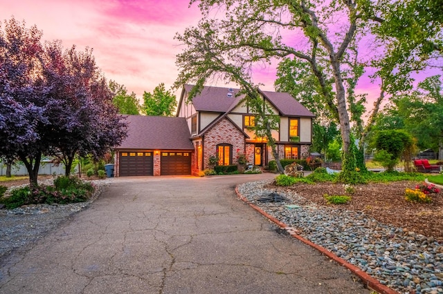 2990 Forest Hills Dr, Redding, CA 96002 - tudor-style house with an attached garage, asphalt driveway, and stucco siding