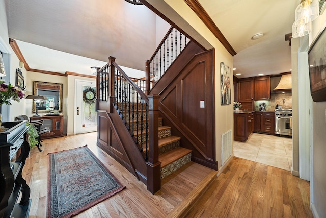 2990 Forest Hills Dr, Redding, CA 96002 - stairs featuring crown molding, wood finished floors, and baseboards