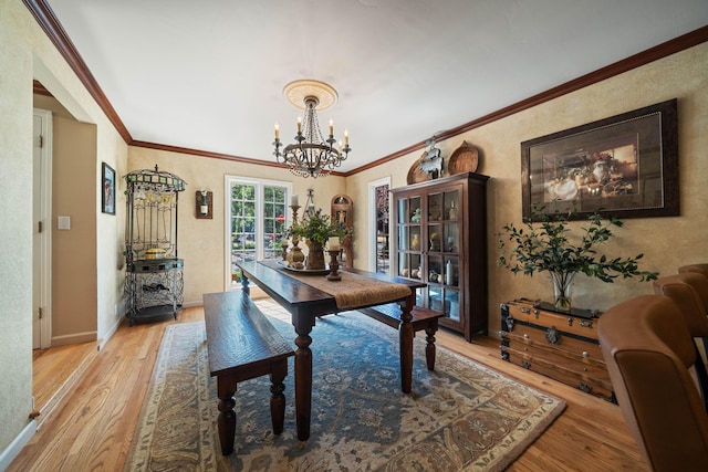 2990 Forest Hills Dr, Redding, CA 96002 - dining area with light wood-style flooring, a chandelier, ornamental molding, baseboards, and french doors