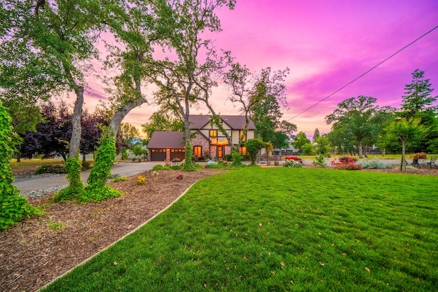 2990 Forest Hills Dr, Redding, CA 96002 - yard at dusk featuring asphalt driveway, a garage, and a yard