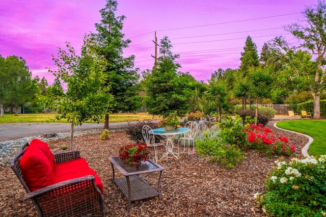 2990 Forest Hills Dr, Redding, CA 96002 - yard at dusk with a patio area and view of wooded area