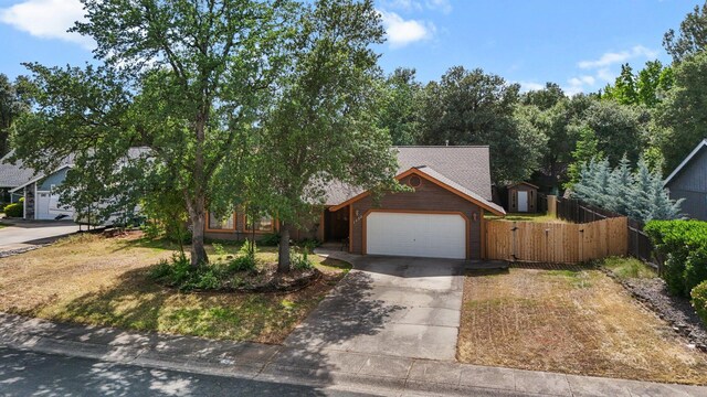 1152 Edgewood Dr, Redding, CA 96003 - view of front of house with fence, an attached garage, driveway, a gate, and a shingled roof