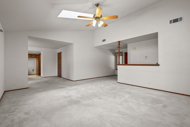 1152 Edgewood Dr, Redding, CA 96003 - unfurnished living room with ceiling fan, baseboards, a skylight, carpet floors, and high vaulted ceiling