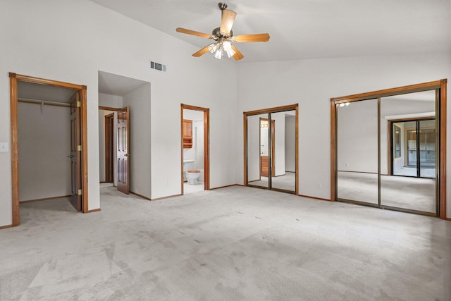 1152 Edgewood Dr, Redding, CA 96003 - unfurnished bedroom with multiple closets, carpet flooring, high vaulted ceiling, baseboards, and a ceiling fan