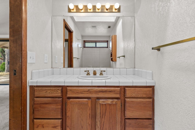 1152 Edgewood Dr, Redding, CA 96003 - bathroom featuring a textured wall and vanity