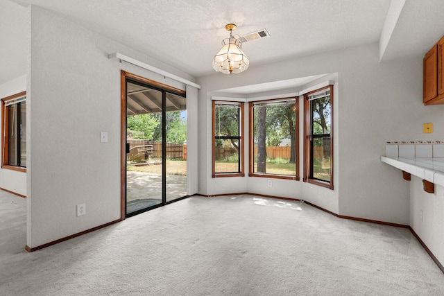 1152 Edgewood Dr, Redding, CA 96003 - unfurnished dining area featuring plenty of natural light, light carpet, a chandelier, and baseboards