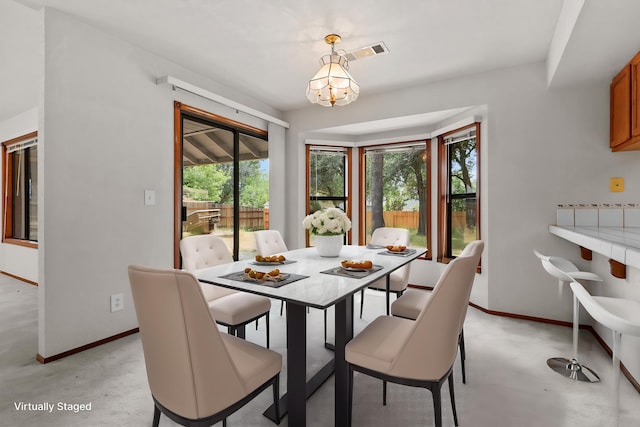 1152 Edgewood Dr, Redding, CA 96003 - dining space with baseboards, a chandelier, and finished concrete floors