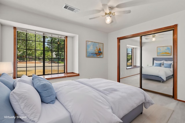 1152 Edgewood Dr, Redding, CA 96003 - bedroom with light colored carpet, multiple windows, a closet, and a ceiling fan