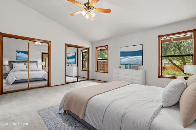 1152 Edgewood Dr, Redding, CA 96003 - bedroom with two closets, multiple windows, light colored carpet, vaulted ceiling, and a ceiling fan