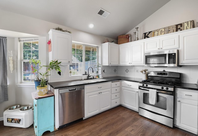 2773 Crystal Tree Dr, Redding, CA 96001 - kitchen with stainless steel appliances, a sink, dark countertops, healthy amount of natural light, and recessed lighting