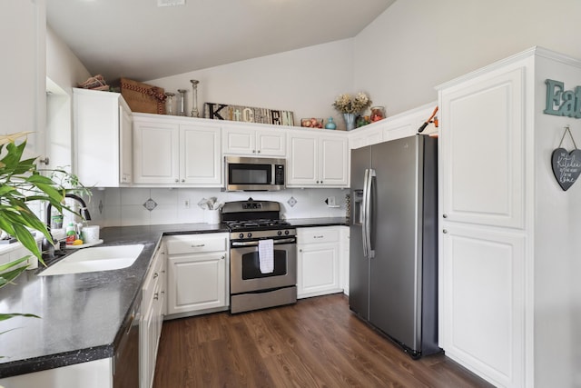 2773 Crystal Tree Dr, Redding, CA 96001 - kitchen with stainless steel appliances, dark countertops, white cabinets, dark wood finished floors, and high vaulted ceiling
