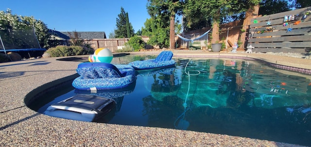 2773 Crystal Tree Dr, Redding, CA 96001 - view of pool with a fenced backyard and a trampoline