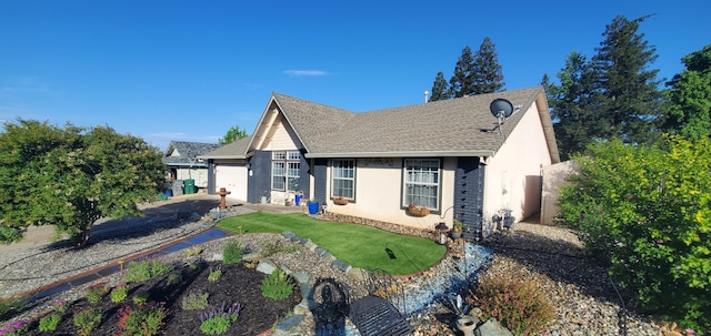 2773 Crystal Tree Dr, Redding, CA 96001 - view of front of home featuring a garage, roof with shingles, stucco siding, and a putting area