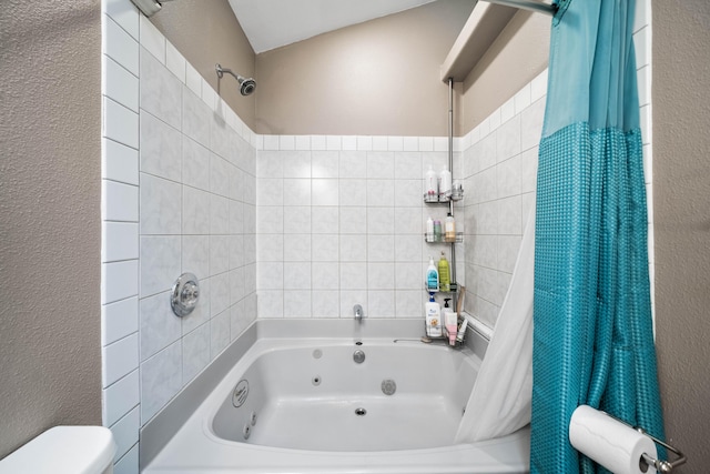 3608 Oasis Rd, Redding, CA 96003 - full bathroom featuring a textured wall, a combined bath / shower with jetted tub, and toilet