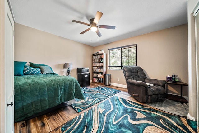 3608 Oasis Rd, Redding, CA 96003 - bedroom with wood finished floors, baseboards, and a ceiling fan